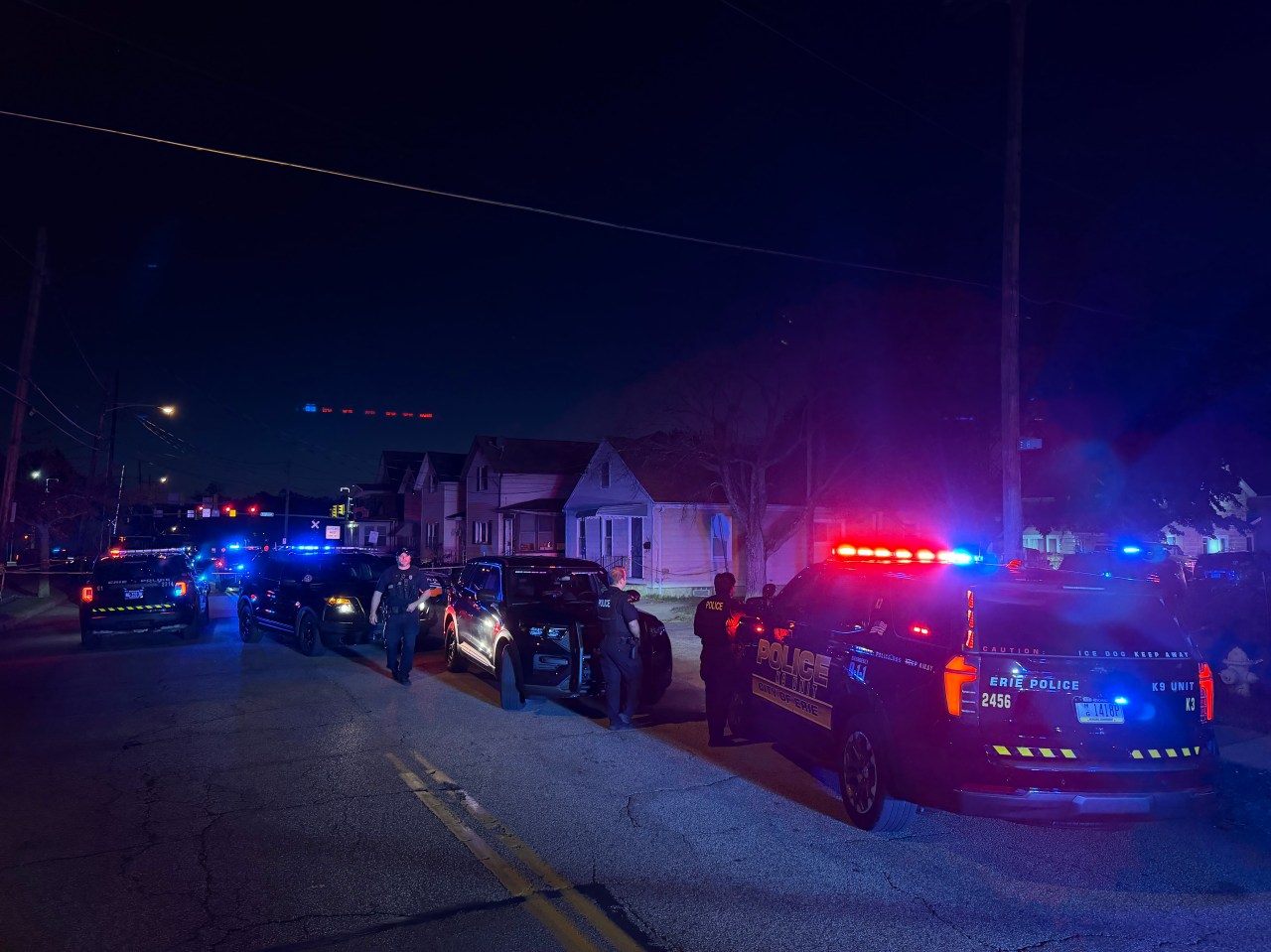 Police vehicles cordon off the scene on Erie’s East Side