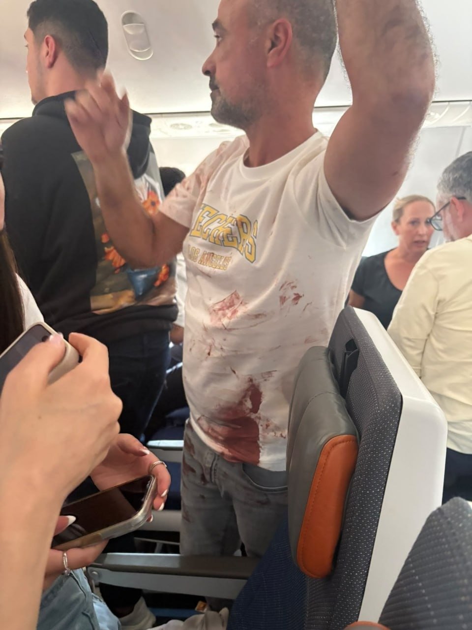 A passenger who intervened, his shirt stained with blood