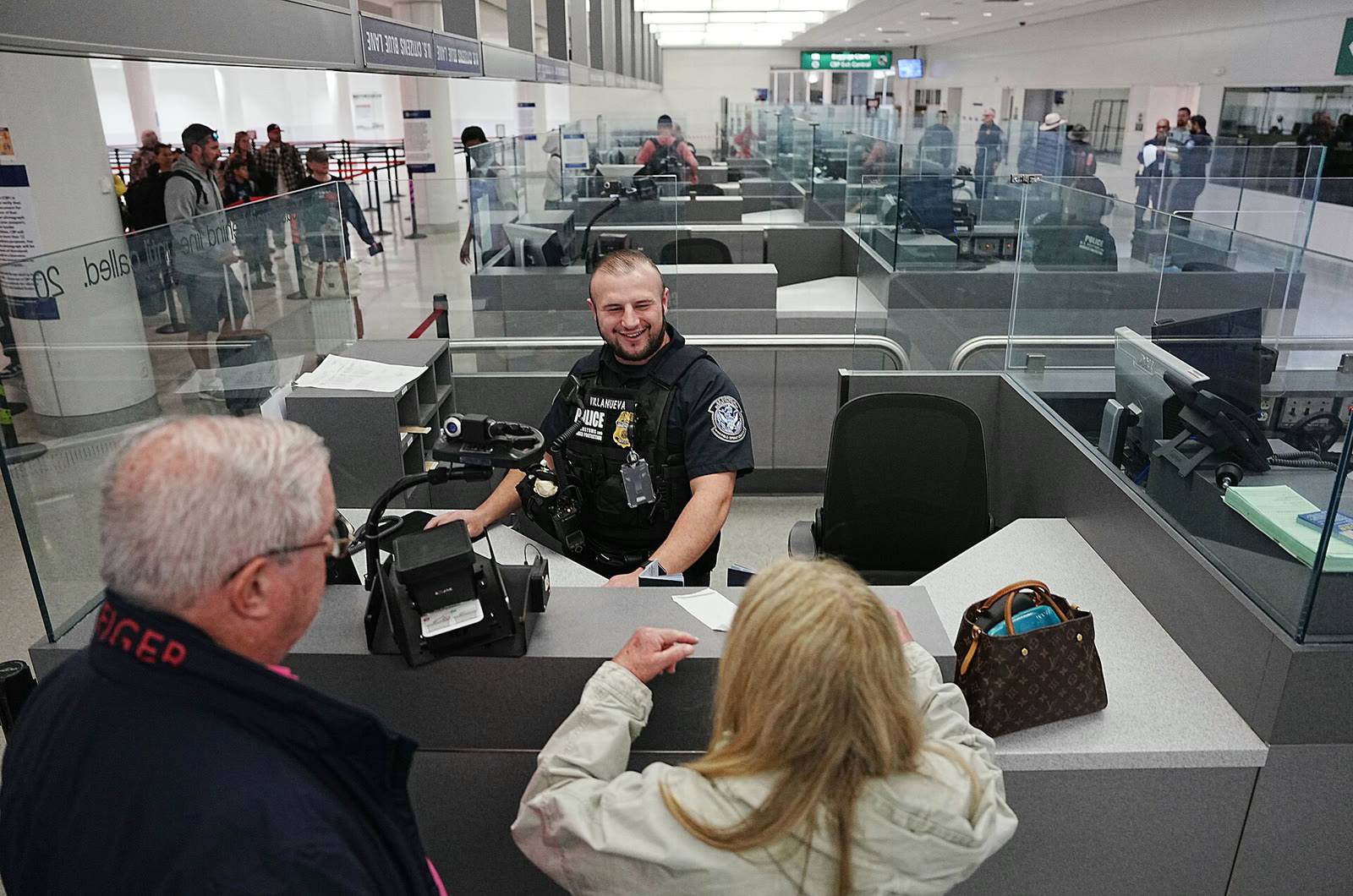 A CBP officer processing travelers at an airport (file photo)