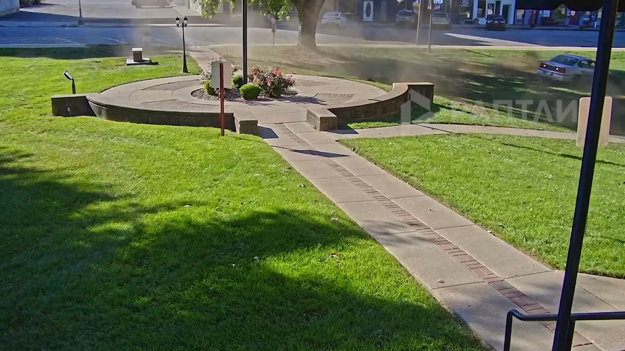 The car keeps circling, leaving tracks on the grass