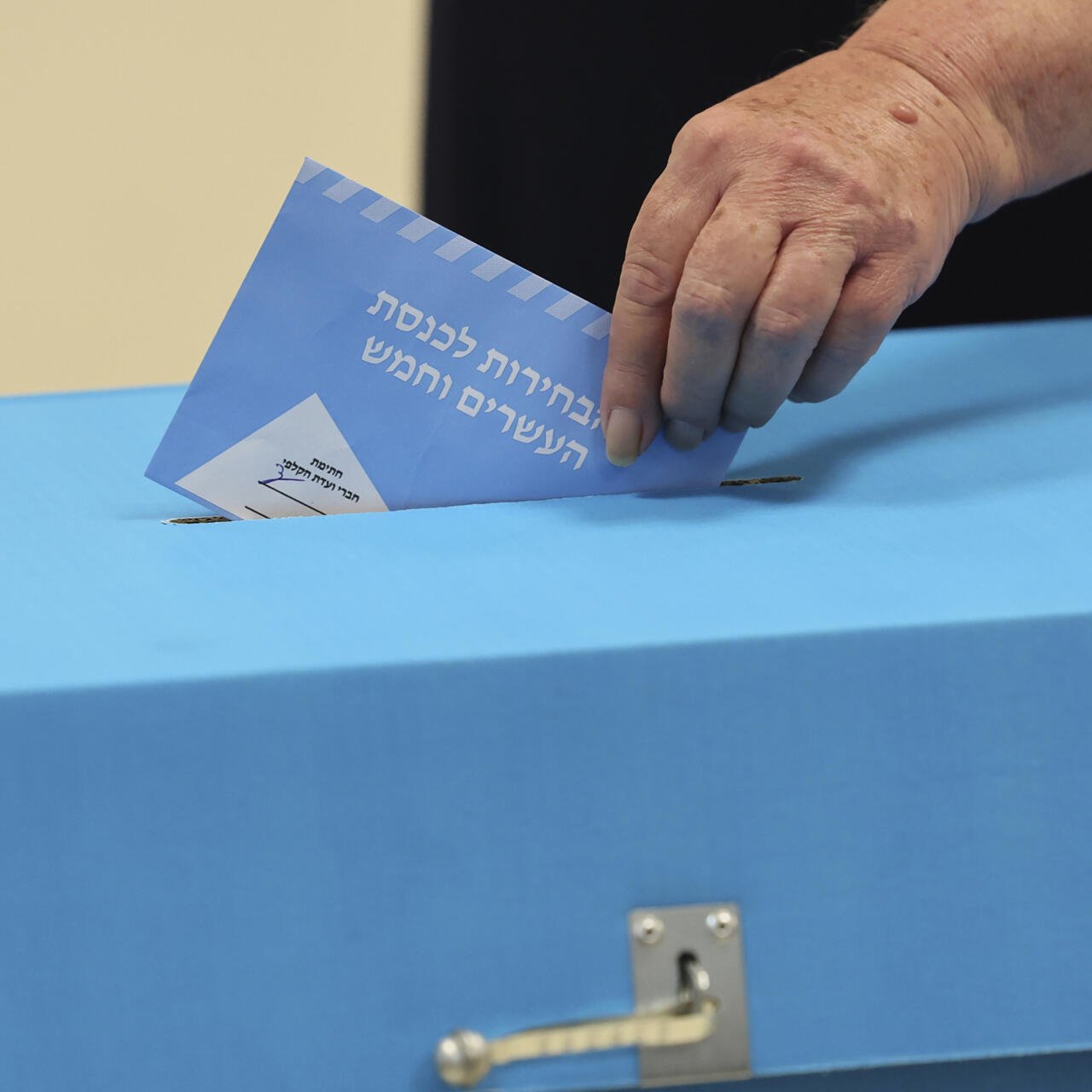 A voter casts a ballot in the Knesset election