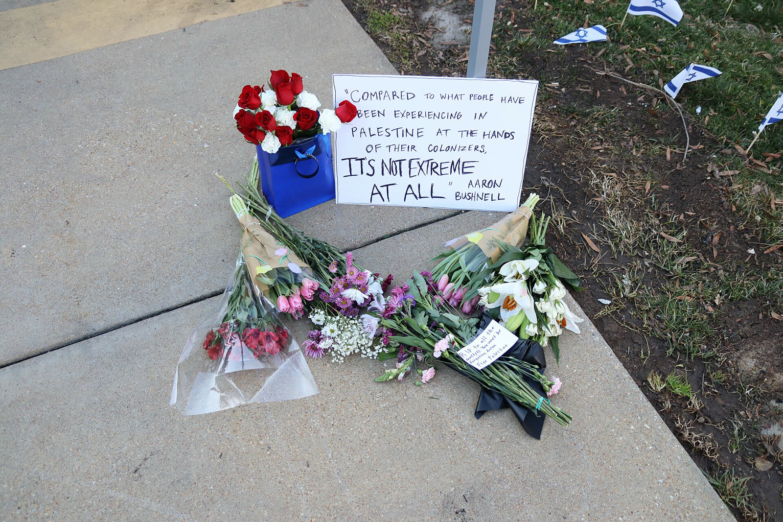 Flowers and a note quoting Bushnell left outside the embassy, February 26, 2024