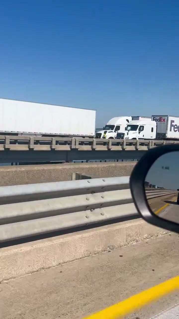 Tractor-trailers stranded on the bridge after the crash