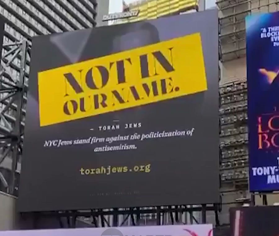 Times Square billboard reading “Not in our name”