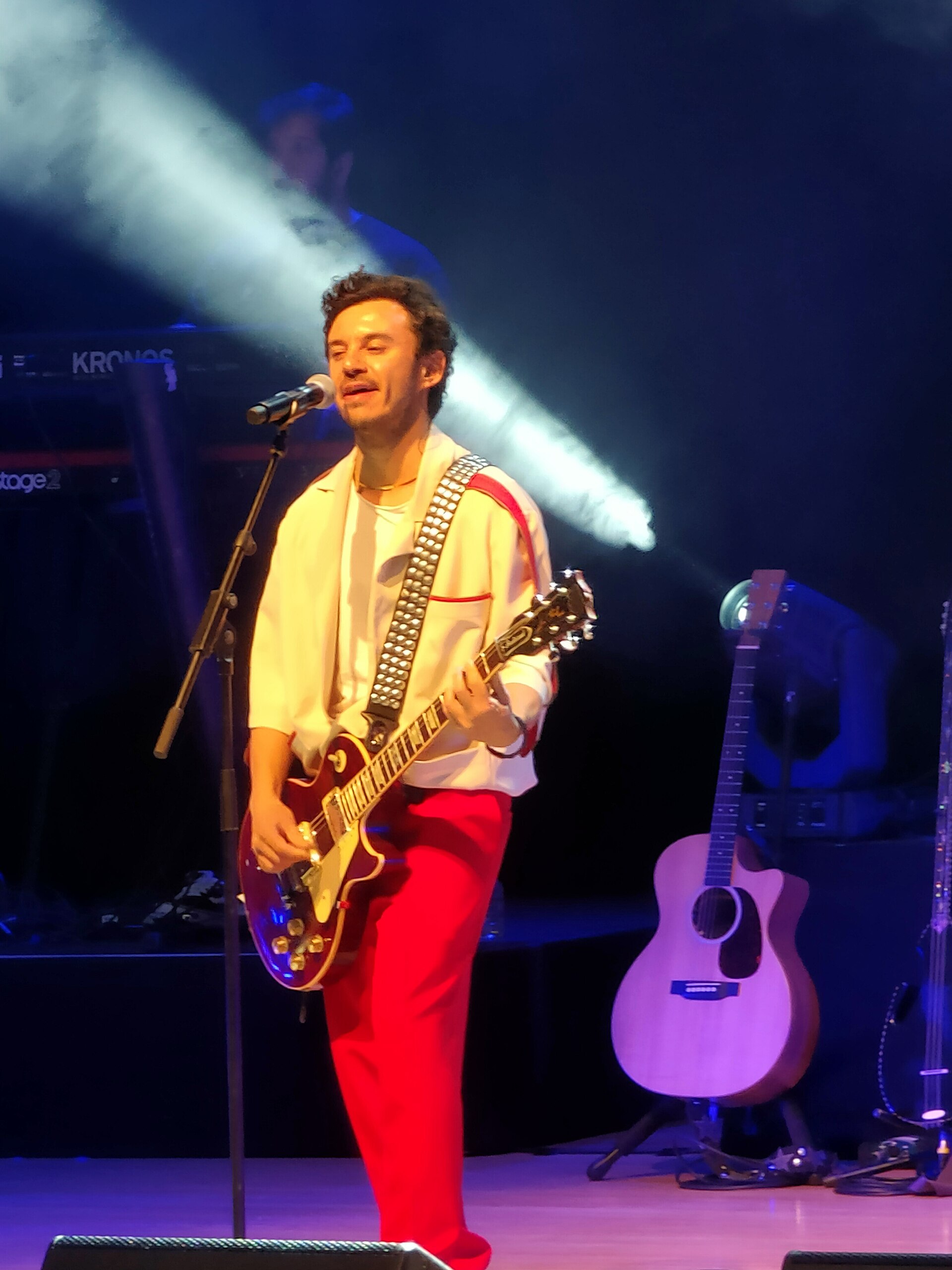 Buray playing guitar during a concert