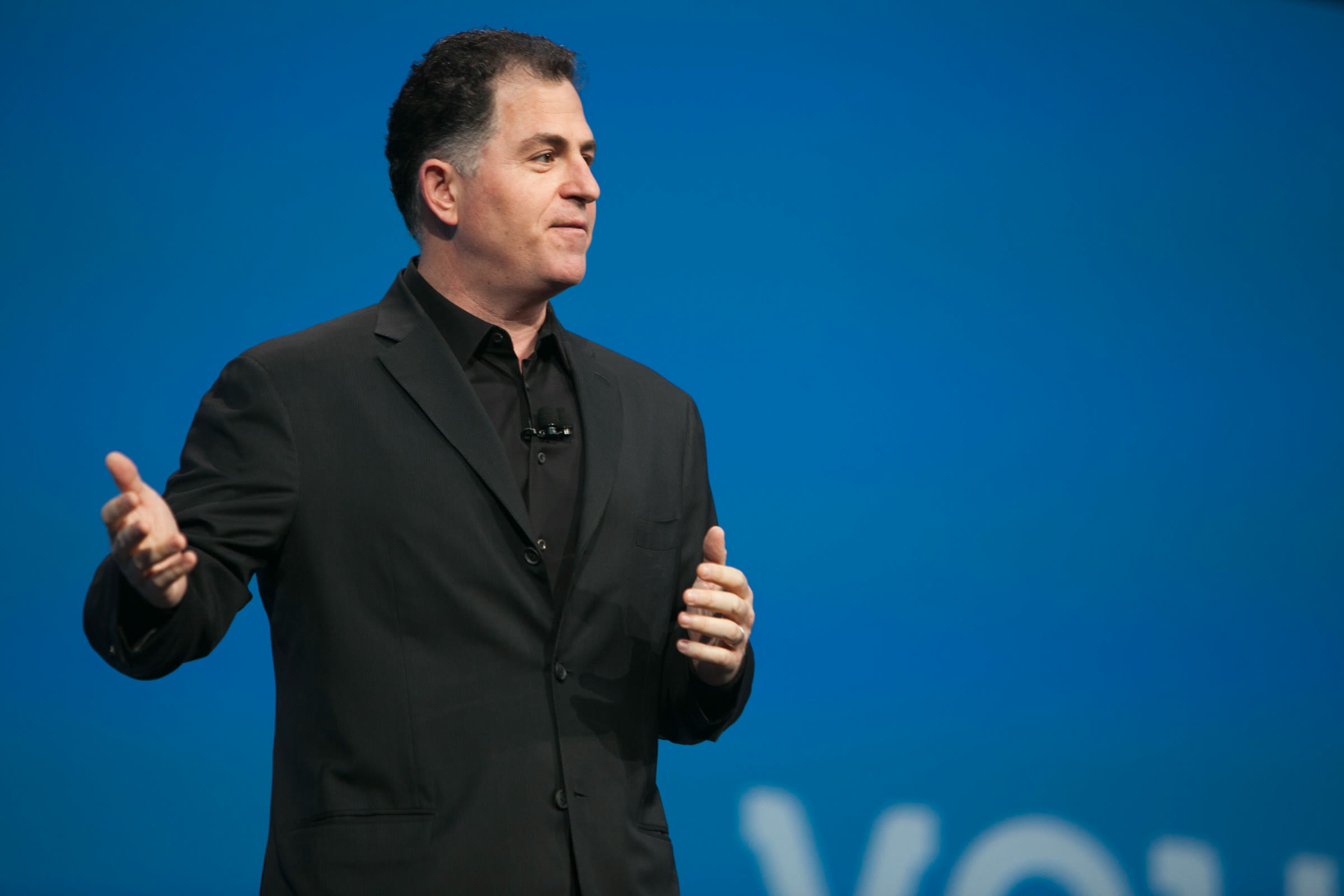 Michael Dell speaks on stage at a technology conference