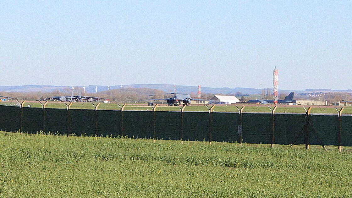 The perimeter fence of RAF Fairford with US bombers on the airfield, March 2026